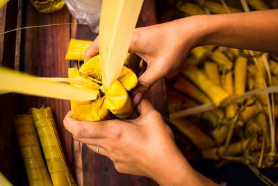 Midsection of man working on yellow flower