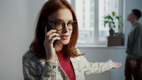 Portrait of young woman using mobile phone