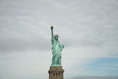 Low angle view of statue against cloudy sky