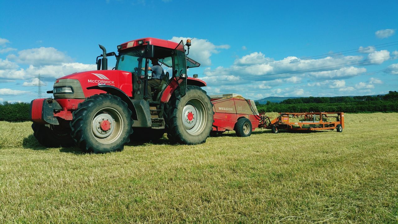 transportation, land vehicle, field, mode of transport, sky, grass, landscape, rural scene, tractor, car, agriculture, cloud - sky, grassy, farm, stationary, cloud, agricultural machinery, day, outdoors, abandoned