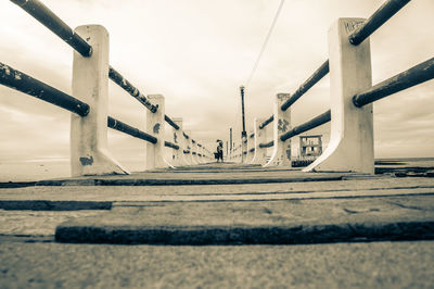 Surface level of bridge over road against sky