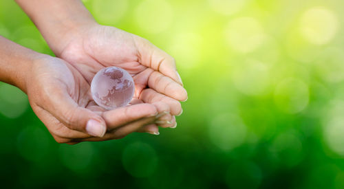 Cropped hands holding crystal ball