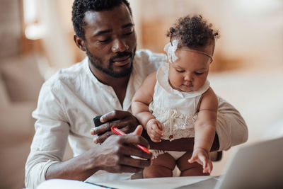 Father and son using smart phone