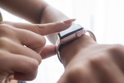 Close-up of woman wearing smart watch