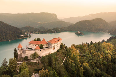 High angle view of lake and buildings against sky