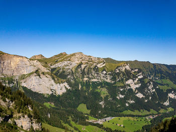 Scenic view of mountains against clear blue sky