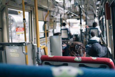 Rear view of passengers traveling in bus