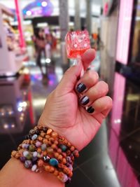 Cropped hand of woman holding lollipop