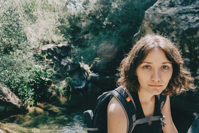 Girl sitting looking at camera in the mountains of prades, tarragona, spain