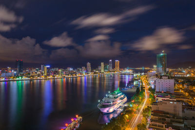 Panoramic view of illuminated city buildings against sky at night