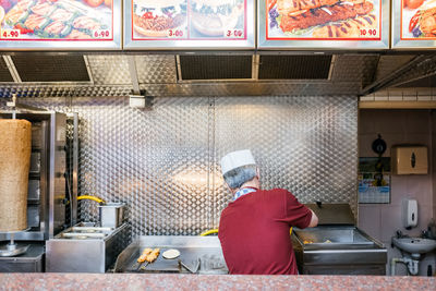 Rear view of man working at restaurant