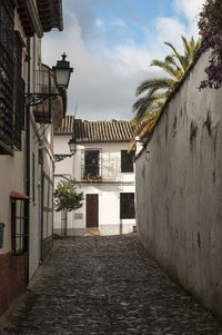 Alley amidst buildings against sky