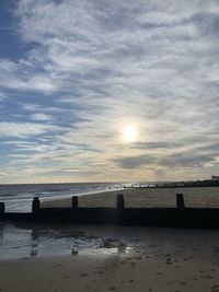 Scenic view of beach against sky during sunset