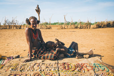 Portrait of young man sitting on land