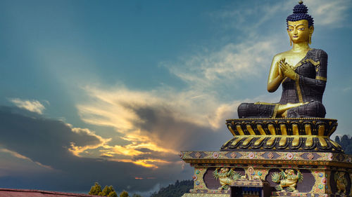 Low angle view of statue against sky during sunset