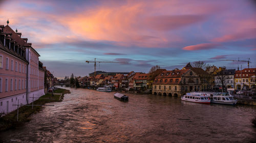 Boats in canal with buildings in background