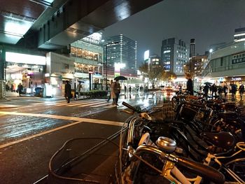 People in illuminated city at night