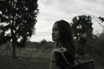 Young woman in thoughtful emotion standing outdoor