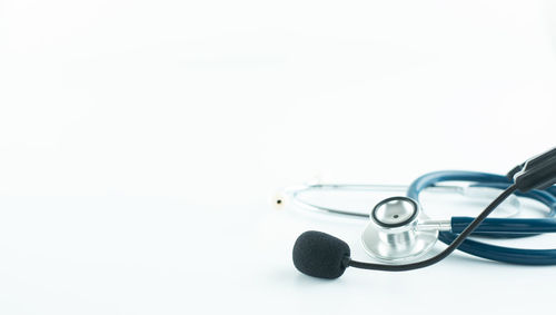 Close-up of eyeglasses on metal against white background