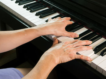 Low angle view of hands playing piano