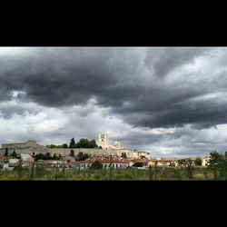 Buildings against cloudy sky