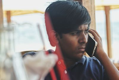 Portrait of young man using mobile phone