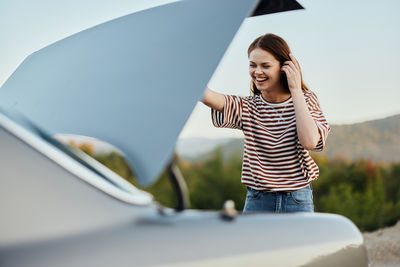 Portrait of young woman using mobile phone