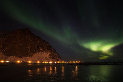 Scenic view of lake against sky at night