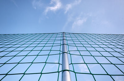 Low angle view of modern building against blue sky