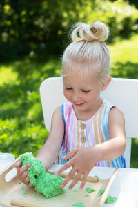 Close-up of girl holding food on table