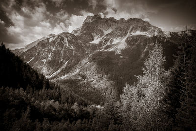 Low angle view of snowcapped mountains against sky