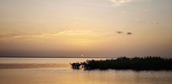 Scenic view of sea against sky at sunset