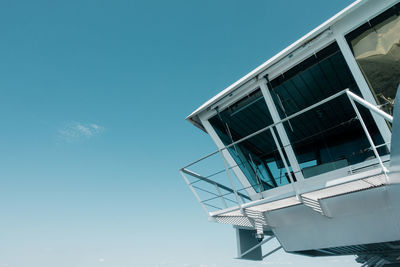 Low angle view of modern building against clear blue sky