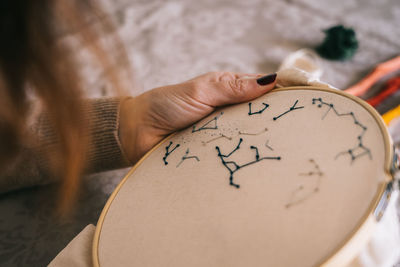 Close-up of hand holding painting