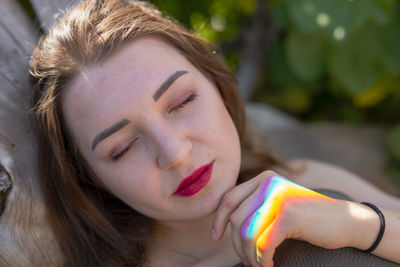 Close-up of thoughtful young woman with eyes closed