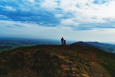 Full length of man standing on mountain against sky