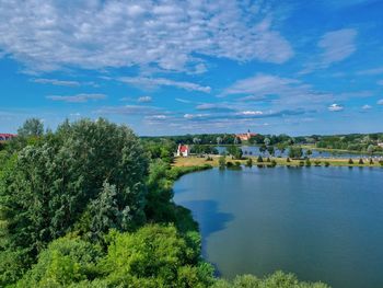 Scenic view of lake by building against sky