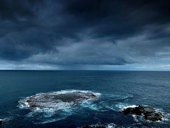 Scenic view of sea against cloudy sky