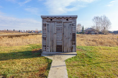 Built structure on field against sky