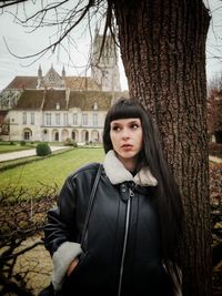 Portrait of woman standing against plants