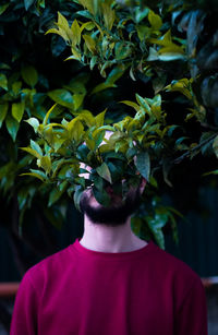 Young man against plants