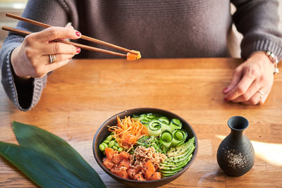 Midsection of woman preparing food on table