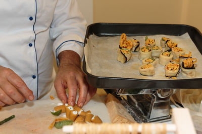 Midsection of man preparing food on table