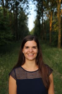 Portrait of smiling woman standing in forest