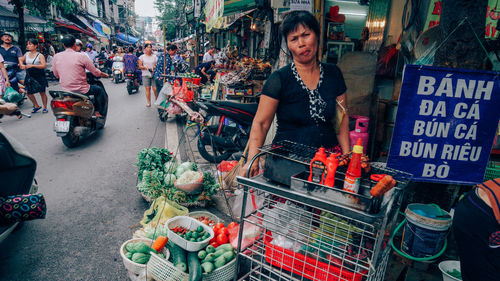 People at market stall in city