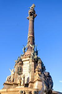 Low angle view of statue against blue sky