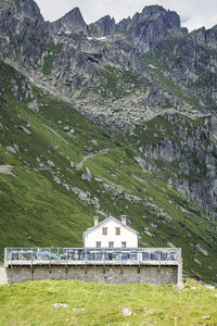 Scenic view of landscape and houses against mountains