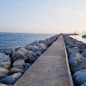 Groyne at sea against sky