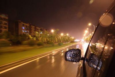 Blurred motion of car on road at night