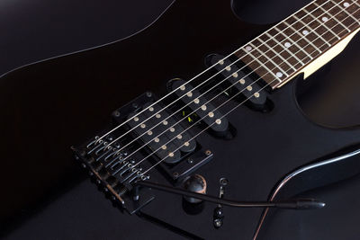 Close-up of guitar against black background